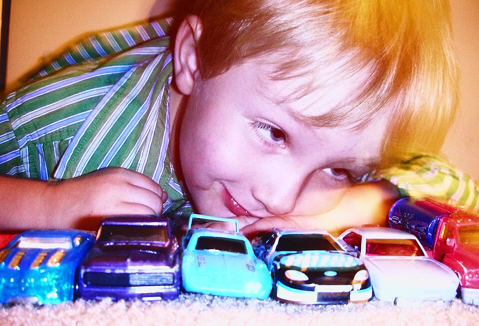 Someone give this kid a Hot Wheel, a model car by Hot Wheels