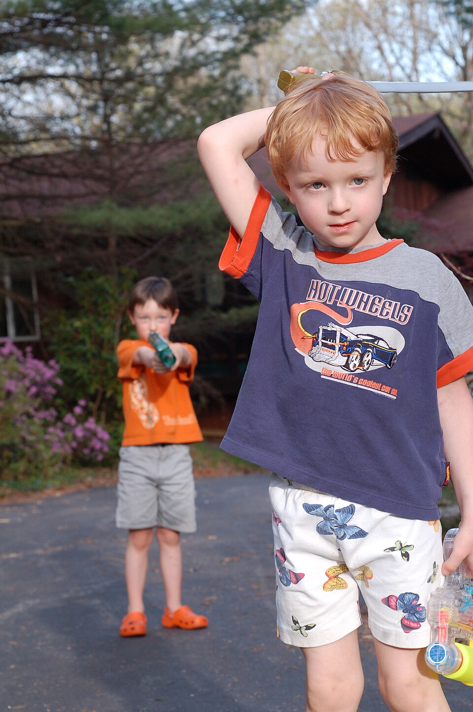 Kid with Hot Wheels shirt, a model car by Hot Wheels