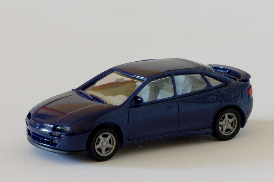Mazda 323F (4690506531), a model car by Herpa